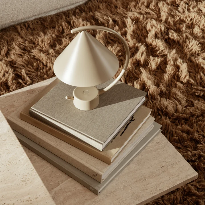 The Meridian table lamp by Ferm Living in cashmere on a travertine coffee table