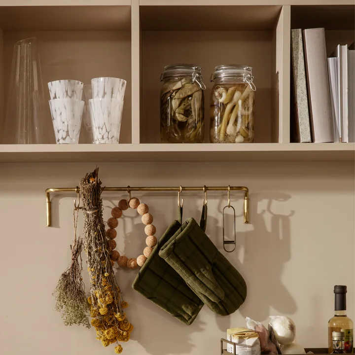 The Casca drinking glass from Ferm Living in milk on a kitchen shelf