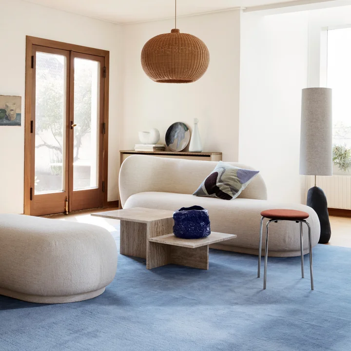 Rico chaise lounge from Ferm Living in a bright living room in combination with an ottoman and a stone coffee table