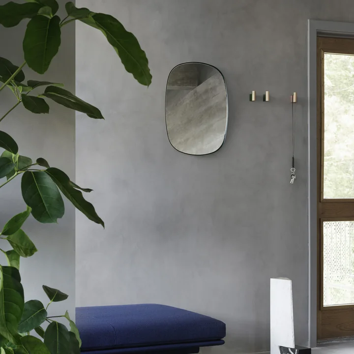 The Framed Mirror Klein from Muuto in the hallway above a blue bench and next to noble wall hooks