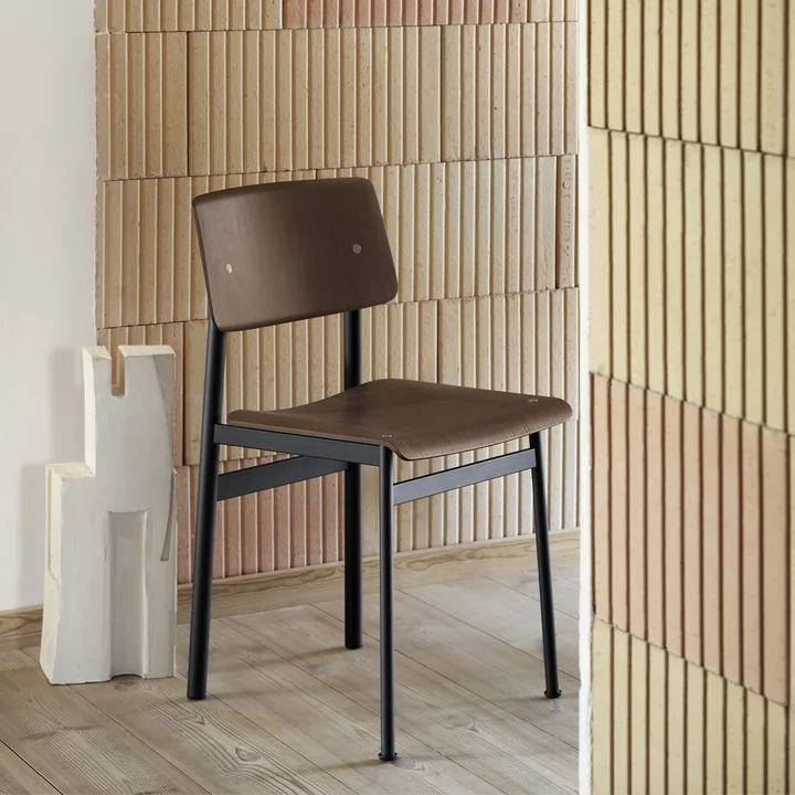 The Loft chair from Muuto surrounded by stone walls