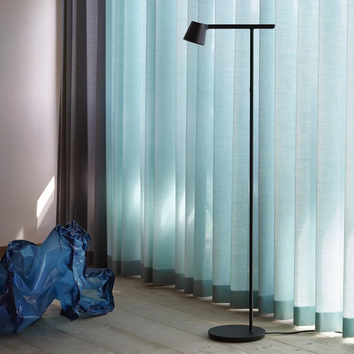 The Tip floor lamp from Muuto in front of light blue curtains