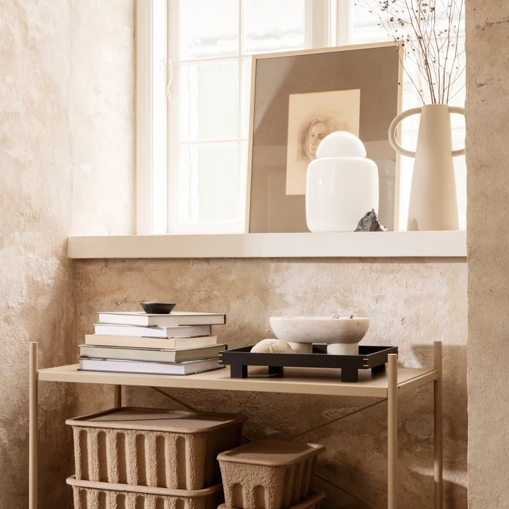 The Bell table lamp by Ferm Living on the windowsill next to works of art and vases