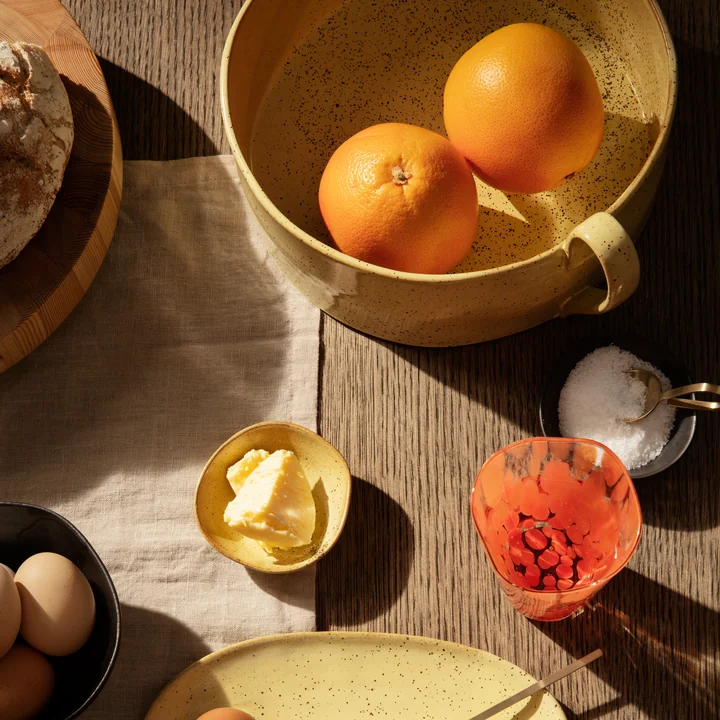 The Flow fruit bowl by Ferm Living on the set breakfast table with oranges, bread and butter