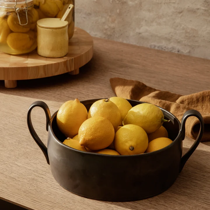 The Flow fruit bowl by Ferm Living in black filled with lemons