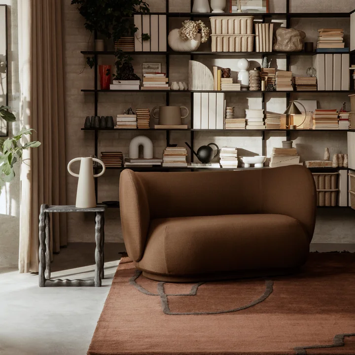 The Rotben coffee table by Ferm Living next to a brown sofa in the stylish living room with earthy tones