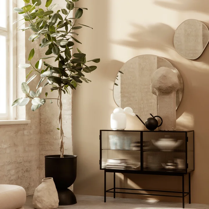 The Pond mirror from Ferm Living above an artfully decorated sideboard