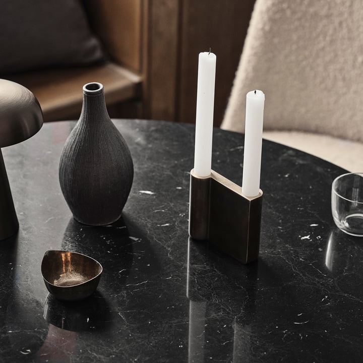 The Collect candleholder from & Tradition with white candles on a black marble table