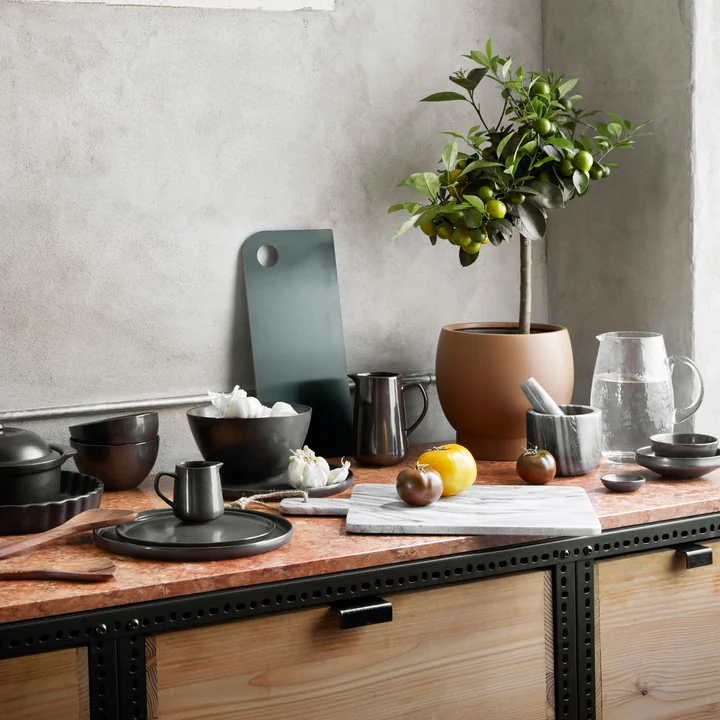 The Vig casserole dish on a granite kitchen counter with many other utensils from Broste Copenhagen