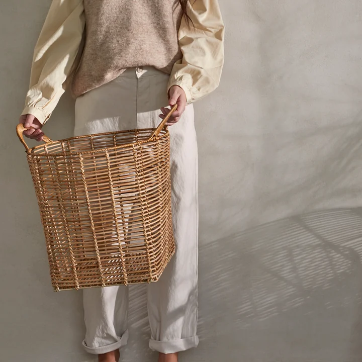 The Safi rattan basket from Broste Copenhagen held by its handles