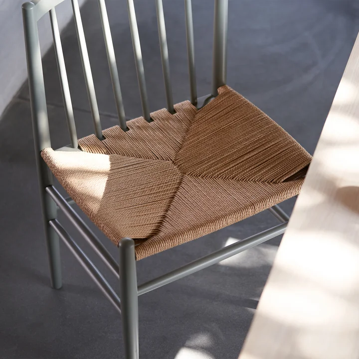 The J80 chair from FDB Møbler in moss gray with a seat made of natural wickerwork