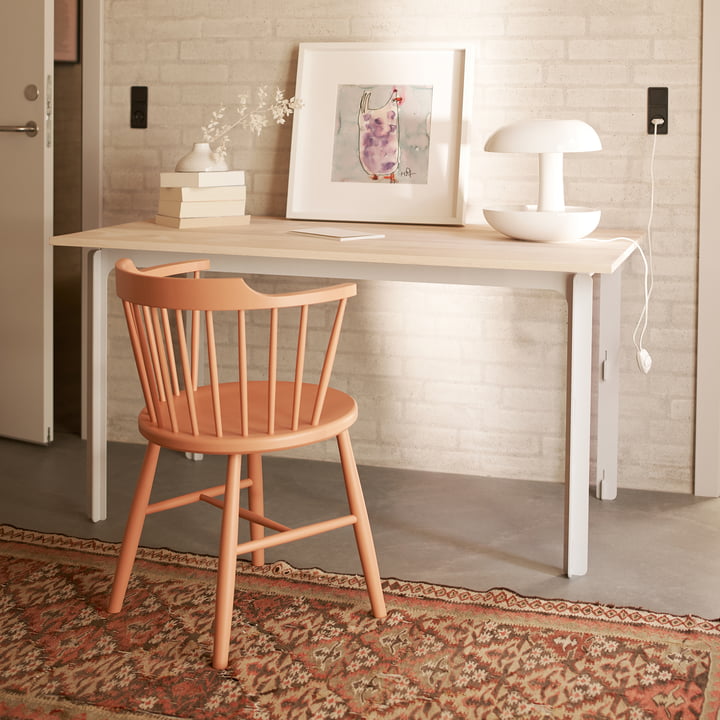 The J18 chair from FDB Møbler in beige at a light-coloured work table