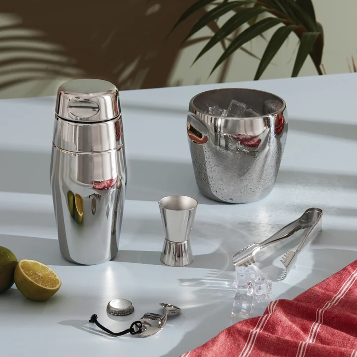 The North Tide stainless steel bar set from Alessi next to limes and ice cream