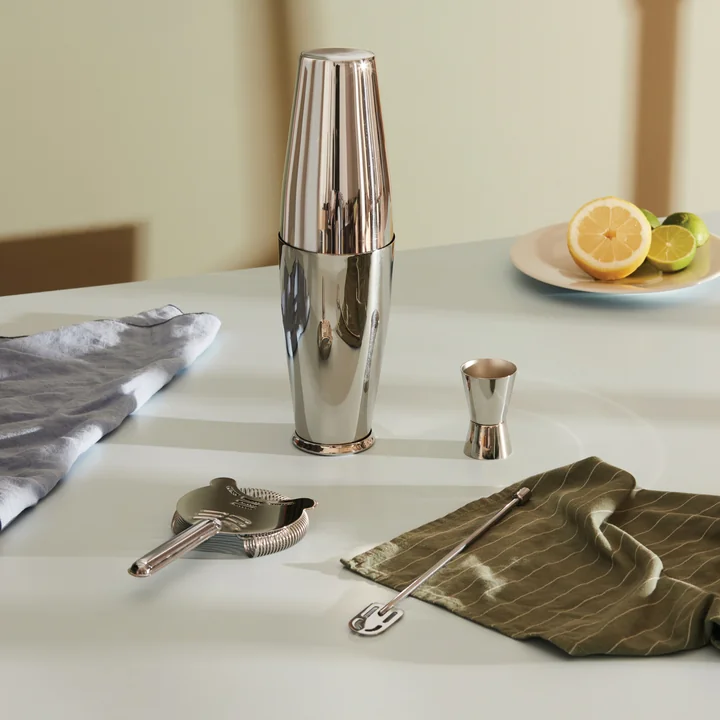 The Boston cocktail set from Alessi in Inox next to kitchen towels and limes