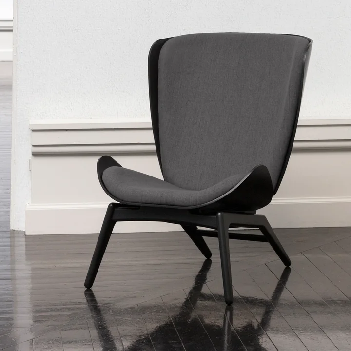The Reader Armchair from Umage in black / slate grey on a black parquet floor