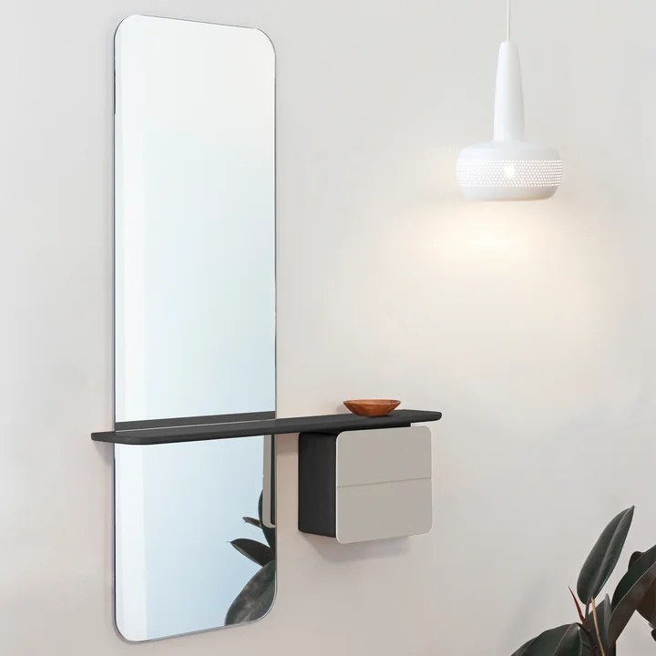 The One More Look mirror from Umage in black / pearl next to a white pendant lamp and a houseplant
