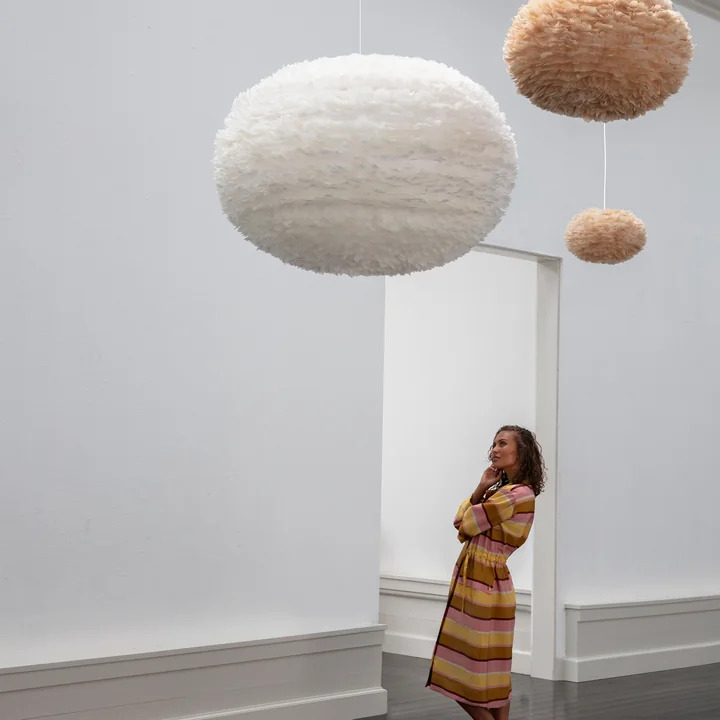 The EOS XXL lampshade from Umage in white in a white room with high ceilings.