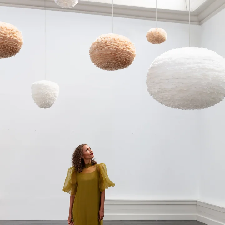 The EOS XXL lampshades from Umage in white in a white room with high ceilings.