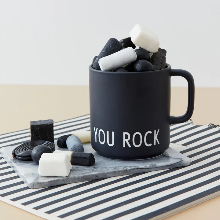 The AJ Favourite porcelain mug from Design Letters in You Rock /black filled with black and white sweets