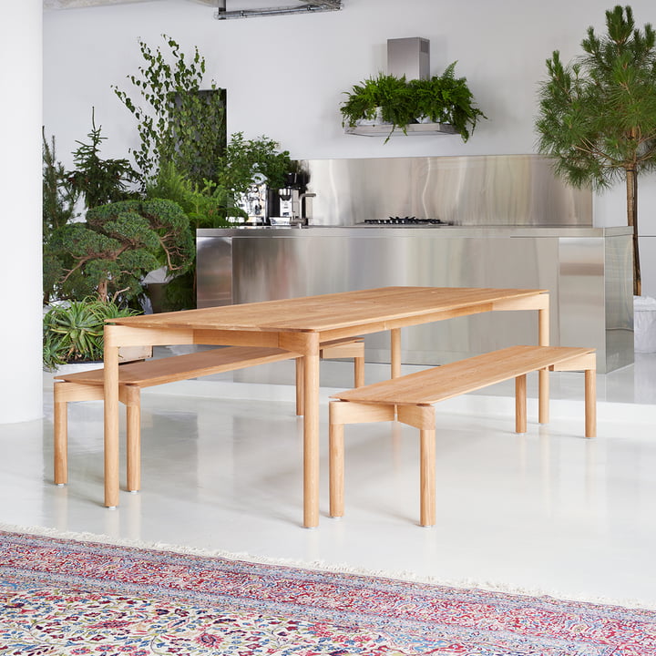 The Wedekind Table with the Wedekind Bench from OUT Objekte unserer Tage in a stainless steel kitchen