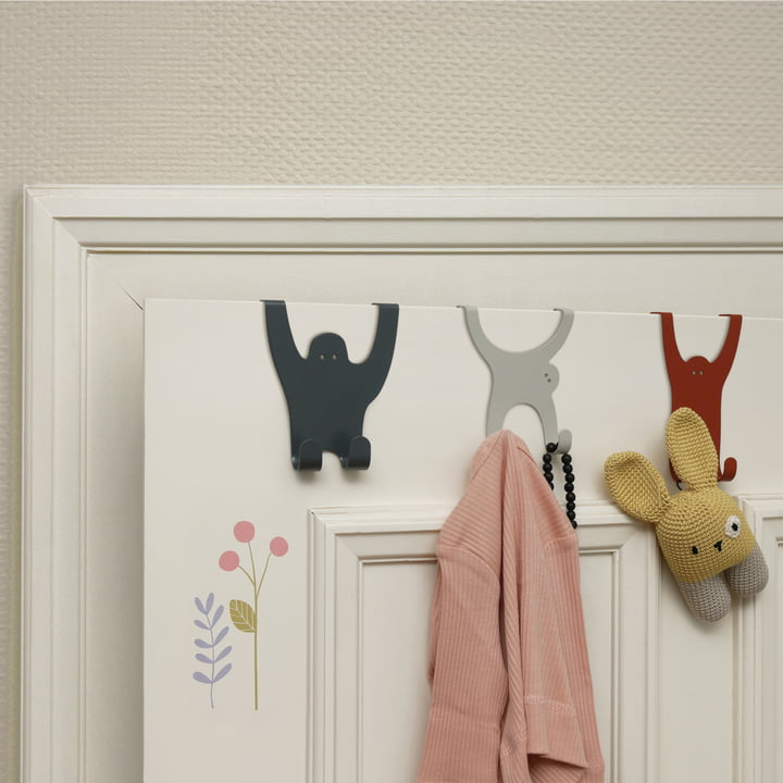 The monkey gang door hooks from vonbox on the door in the children's room with cuddly toy and clothes