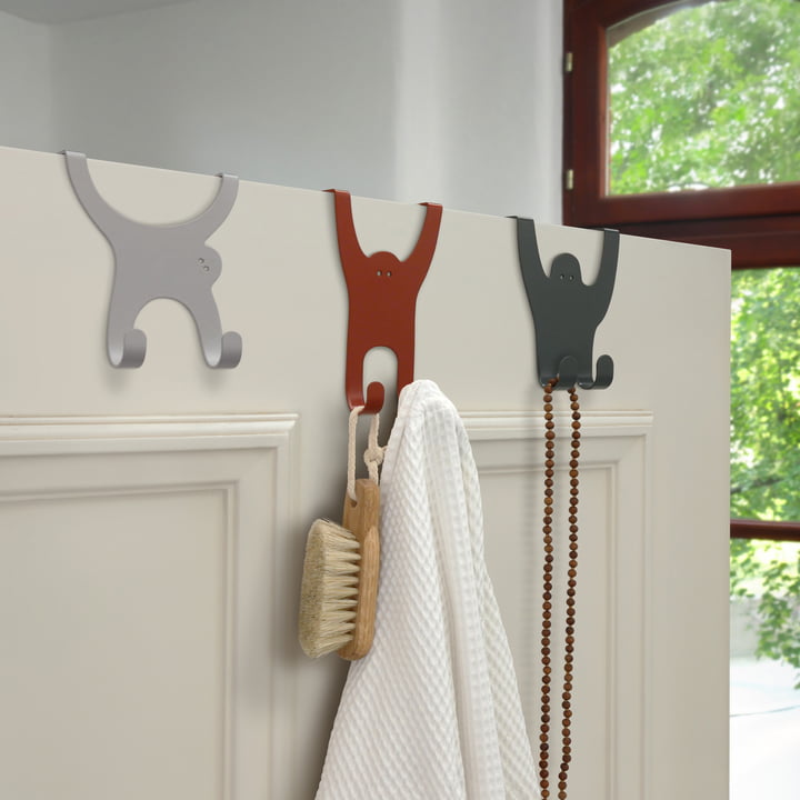 The monkey gang door hooks from vonbox on the door in the bathroom with towels