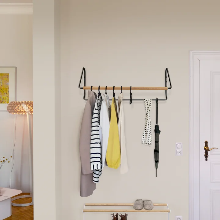 The Onda wall coat rack from vonbox in the hallway above a shoe rack