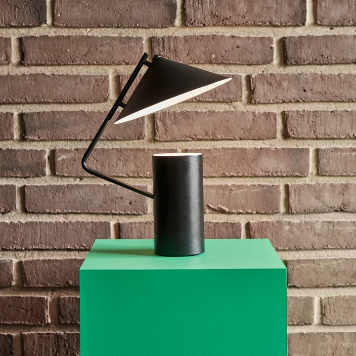 The metal table lamp from Hübsch Interior on a green pedestal