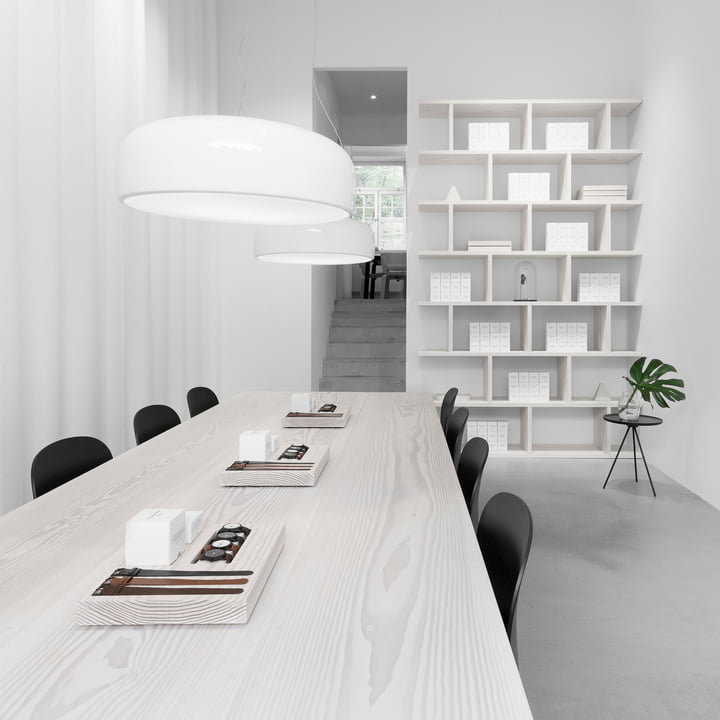 The Smithfield Pro pendant lamp from Flos in white above a long table in a white room