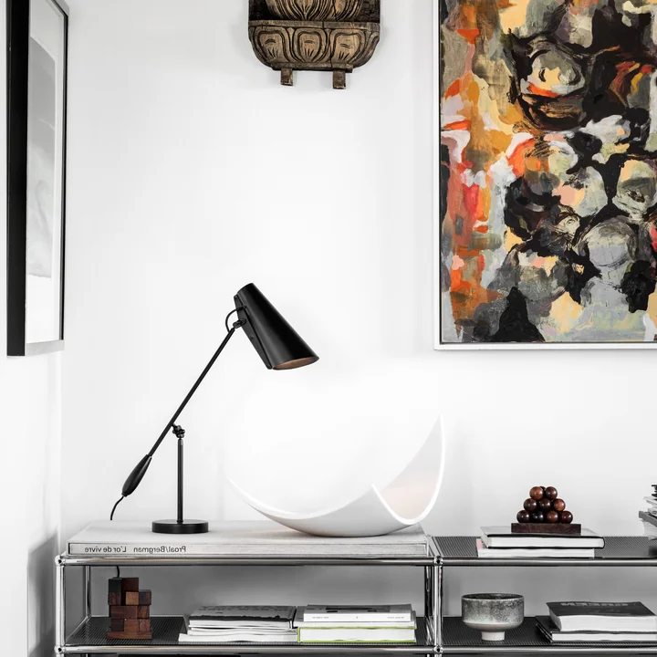 The Birdy Table lamp from Northern on a dresser with many design objects