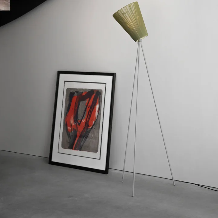 The Oslo Wood floor lamp from Northern next to a work of art