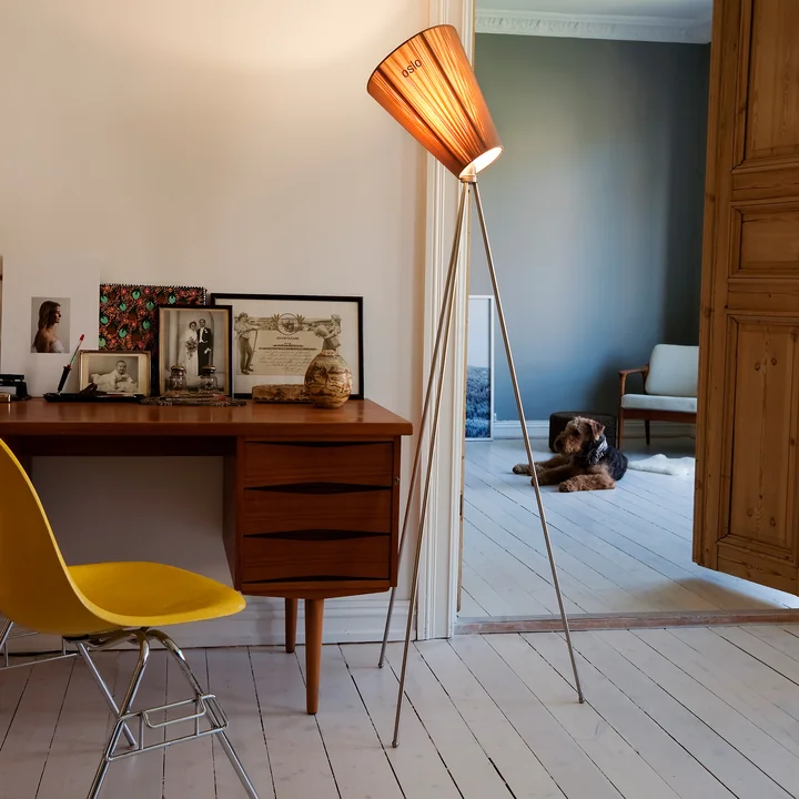 The Oslo Wood floor lamp from Northern beside an antique desk with a yellow chair