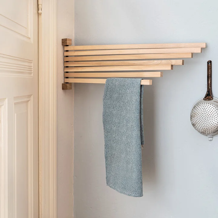 The Pavo wall rack from side by side behind a door