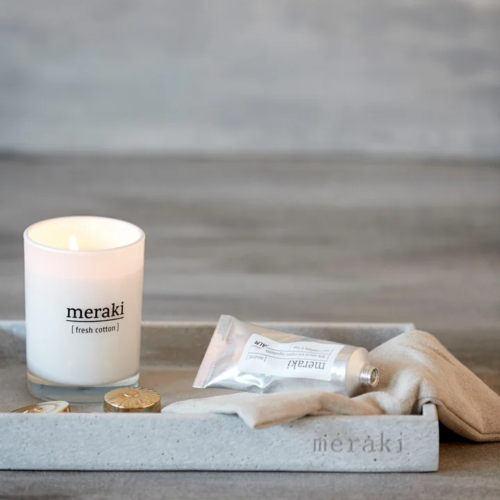 The Fresh Cotton scented candle from Meraki on a tray