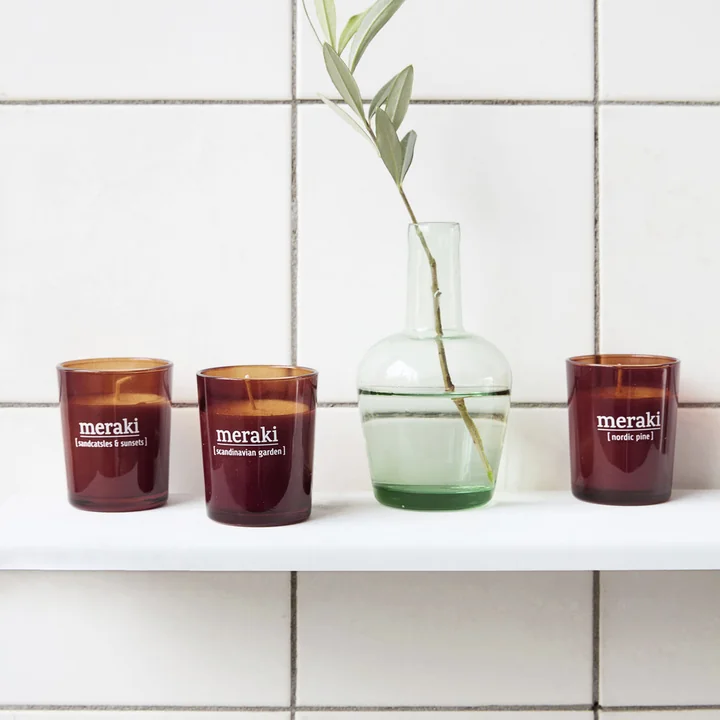 The Nordic Pine scented candles from Meraki on a wall shelf