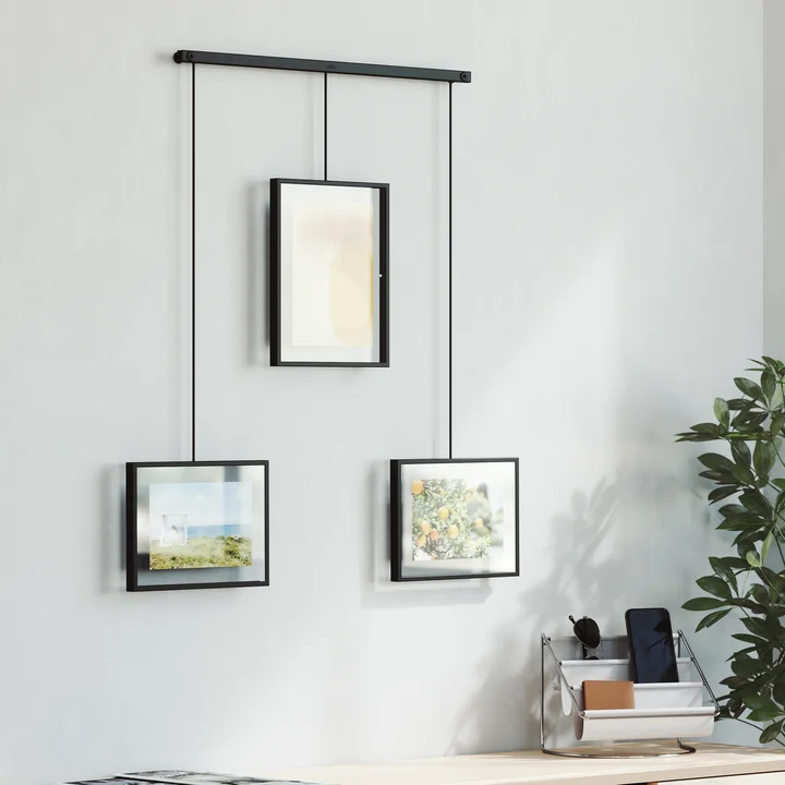 The black Exhibit picture frame from Umbra in a set of 3 above a chest of drawers