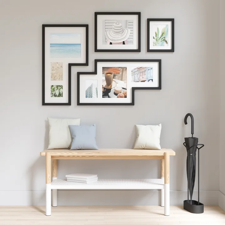 The Mingle Gallery picture frame from Umbra in black above a bench in the hallway