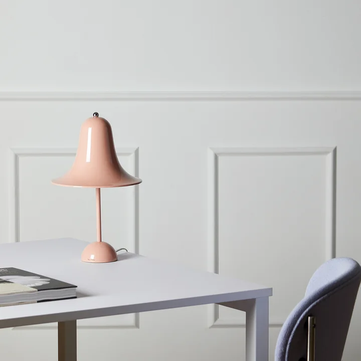 The pink Pantop table lamp from Verpan on a white desk