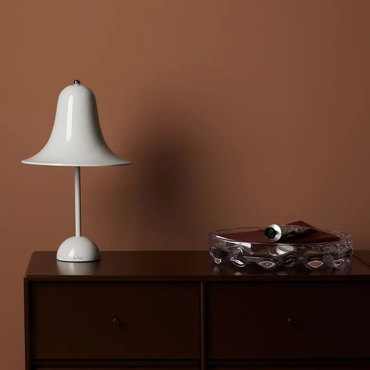 The mint gray Pantop table lamp from Verpan on a dark wooden dresser