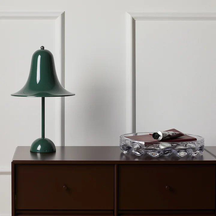 The dark green Pantop table lamp from Verpan on a dark wooden dresser
