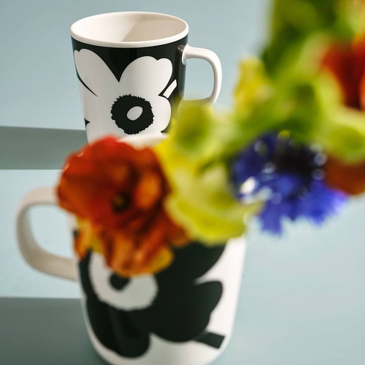 The Unikko pattern from Marimekko on two black and white mugs