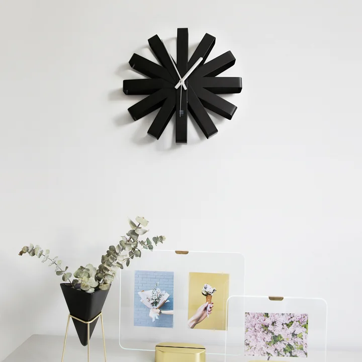 Elegant designer wall clock in the hallway