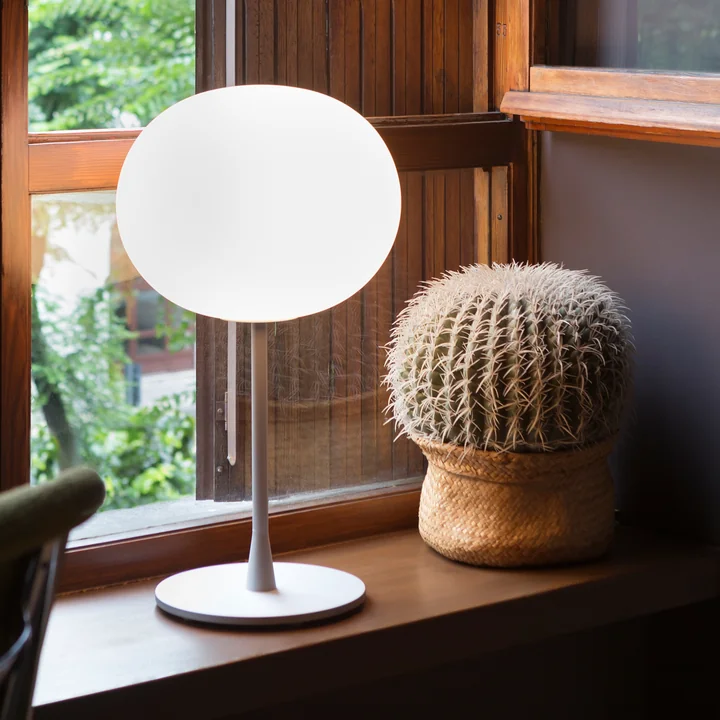 The Glo-Ball T from Flos in silver matt on a windowsill next to a cactus