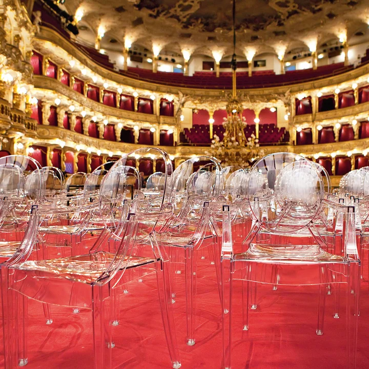 The transparent Louis Ghost Chairs from Kartell in a large opera hall