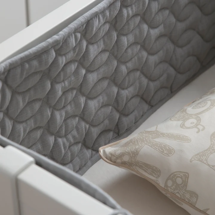 The gray baby crib nest from Sebra in the crib