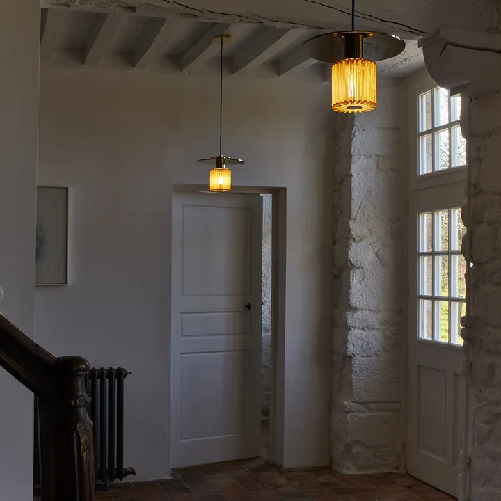 The In the Sun pendant luminaire from DCW in the dark entrance area