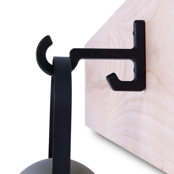 A hook from the set for Guidelight from Weltevree on a wooden rail