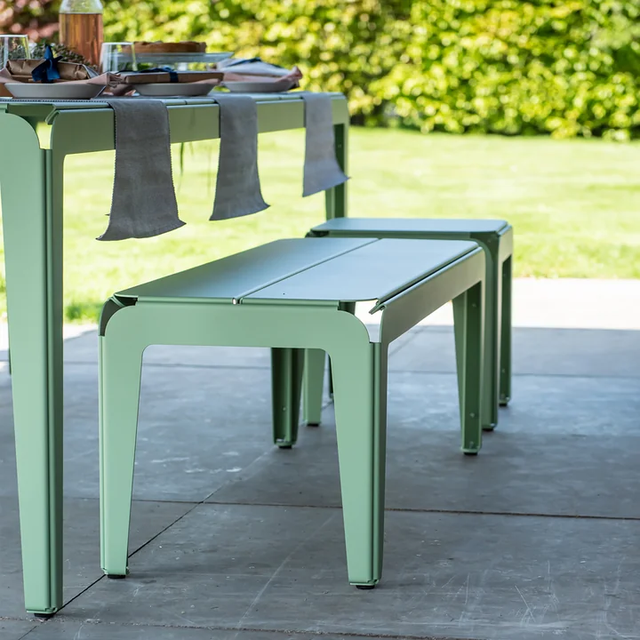 The Bended Bench bench with the bended table on stone slabs