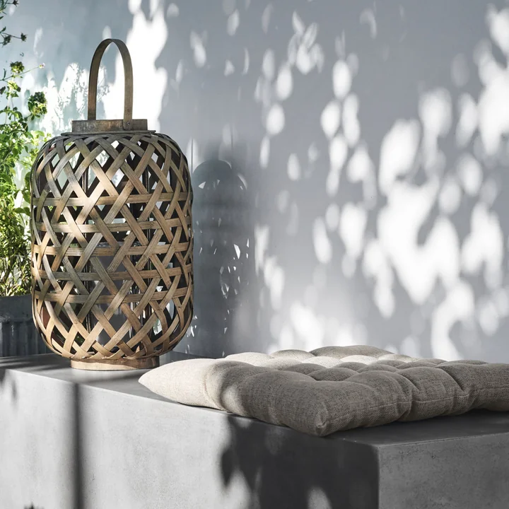 The Fine outdoor cushion from House Doctor on a concrete bench