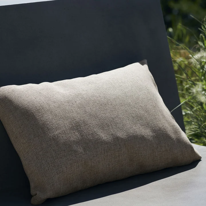 The elongated Fine outdoor cushion from House Doctor on a concrete armchair